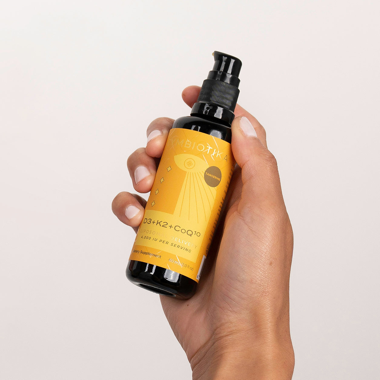 Hand Holding Liposomal Vitamin D3 + K2 + CoQ10